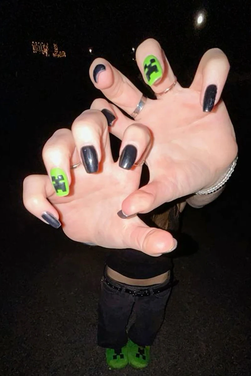 a close-up of woman's nails with minecraft inspired nail look
