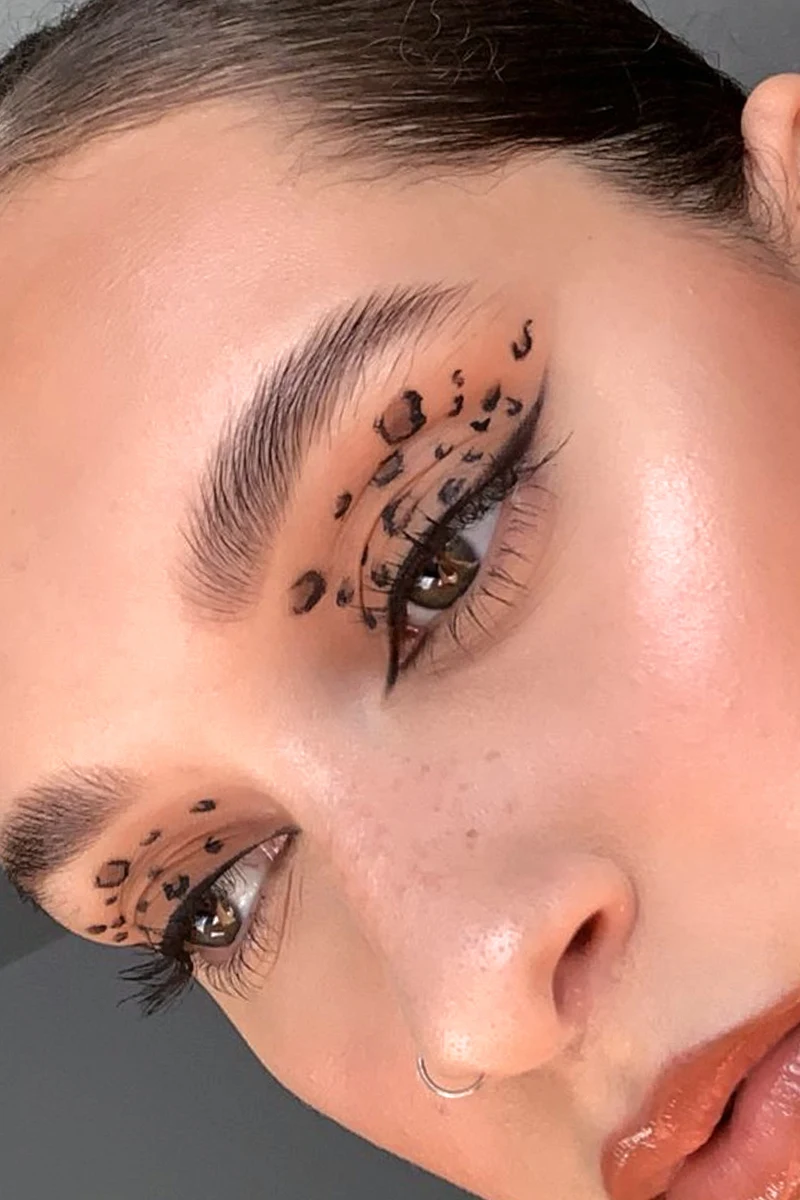 a portrait of a woman with black eyeliner and nude lisptick