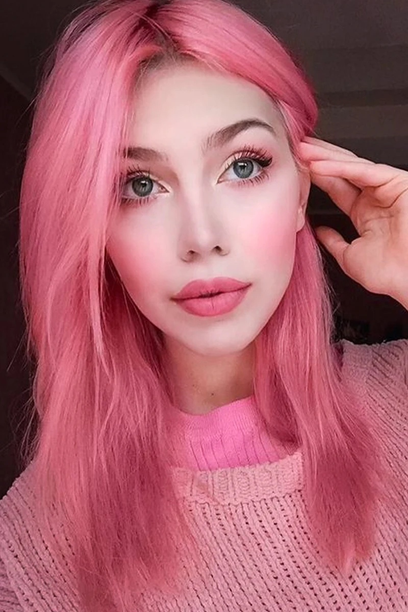 a portrait of a beautiful woman with a barbie pink hair