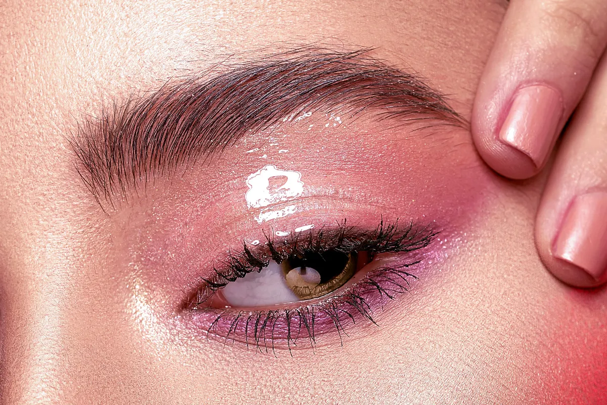 a close-up of woman's eye with a beautiful makeup and lash extensions